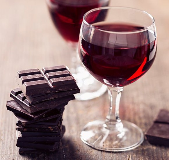 wine goblet with stack of chocolate